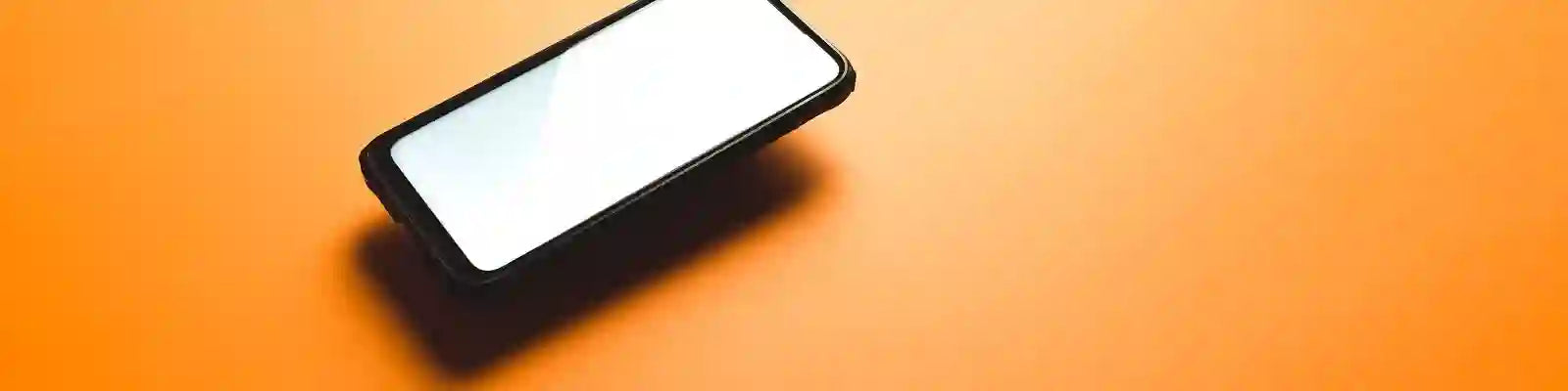 cellphone-levitates-above-an-orange-background Collection Image SA Lot