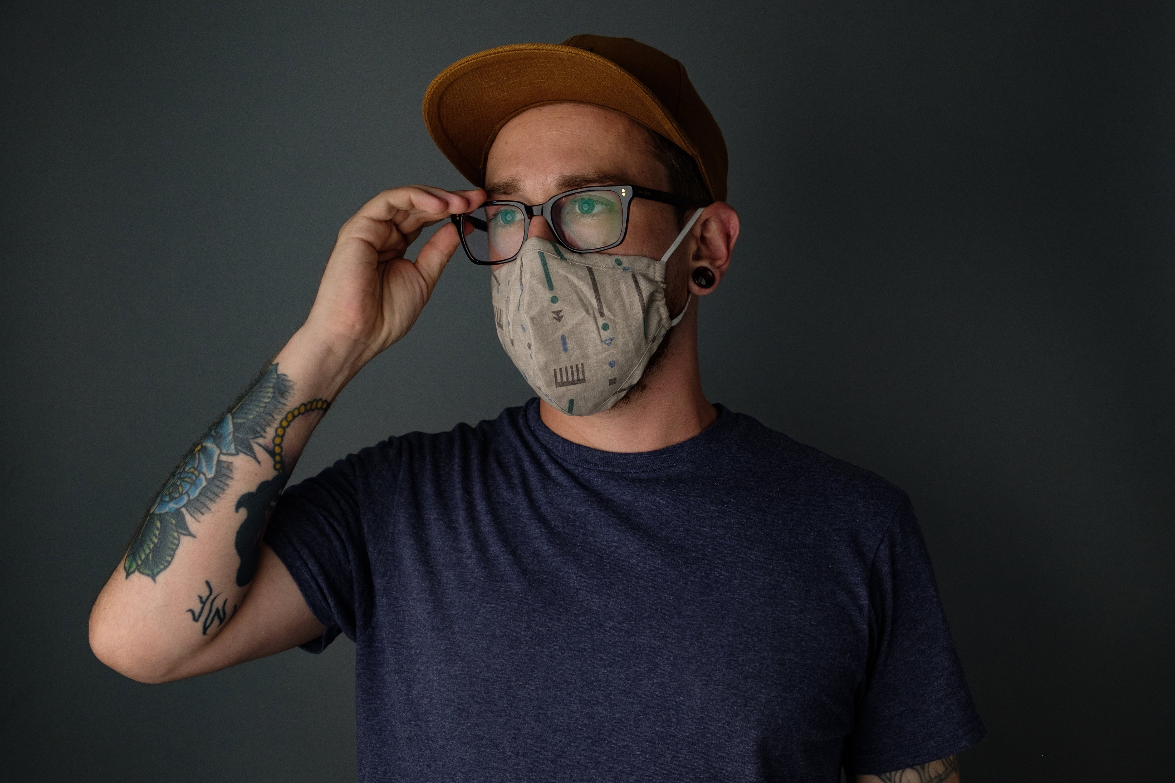 Protective-Equipment-can-safe-your-life-and-it-is-so-design-man-wearing-mask-adjusting-his-glasses