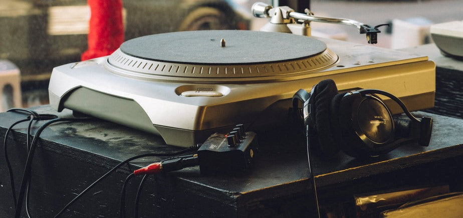 turntable-set-in-a-store-window-with headphones-in-the-foreground