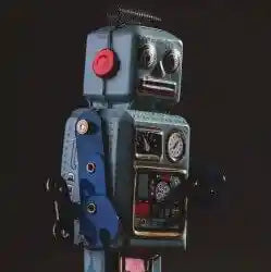black-background-in-the-foreground-is-a-vintage-tin-robot-blue-and-red-looking-to-the-right-250
